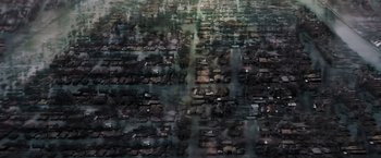 Movie still from “Black as Night” (2021), directed by Maritte Lee Go – An aerial view of a large city with lots of buildings; Extreme Wide shot, High angle