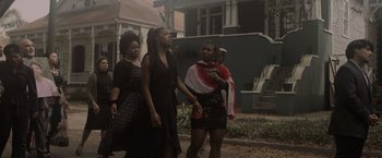Movie still from “Black as Night” (2021), directed by Maritte Lee Go – A group of women walking down a street; Medium shot, Low angle