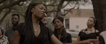 Movie still from “Black as Night” (2021), directed by Maritte Lee Go – A woman with her eyes closed and two other women; Close Up shot, Low angle