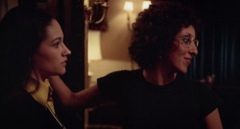 Movie still from “Black Christmas” (1974), directed by Bob Clark – Two women are standing in a living room; Close Up shot, Over the shoulder angle