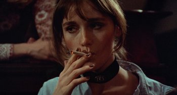 Movie still from “Black Christmas” (1974), directed by Bob Clark – A woman smoking a cigarette while sitting down; Close Up shot, High angle