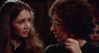 Movie still from “Black Christmas” (1974), directed by Bob Clark – A woman and a man are talking to each other; Close Up shot, Over the shoulder angle