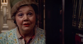 Movie still from “Black Christmas” (1974), directed by Bob Clark – An older woman wearing a floral print shirt; Close Up shot, Over the shoulder angle