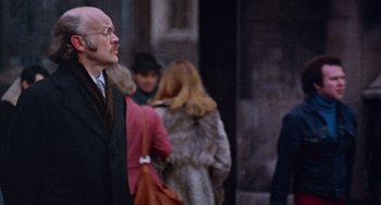 Movie still from “Black Christmas” (1974), directed by Bob Clark – A group of people walking down a street; Close Up shot, Over the shoulder angle