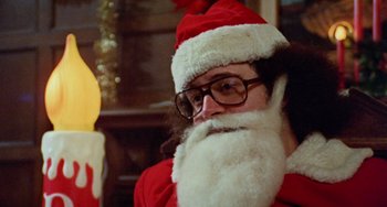 Movie still from “Black Christmas” (1974), directed by Bob Clark – A man dressed as santa claus for a christmas party; Close Up shot, Low angle