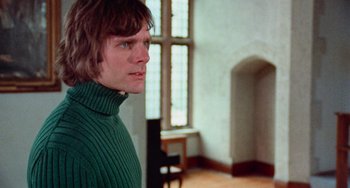 Movie still from “Black Christmas” (1974), directed by Bob Clark – A man wearing a green sweater standing in a room; Close Up shot, Low angle
