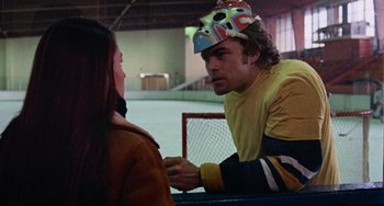 Movie still from “Black Christmas” (1974), directed by Bob Clark – A man and a woman talking to each other in a rink; Medium shot, Over the shoulder angle