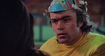 Movie still from “Black Christmas” (1974), directed by Bob Clark – A person with a helmet on his head; Close Up shot, Over the shoulder angle