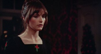 Movie still from “Black Christmas” (1974), directed by Bob Clark – A person wearing a black dress; Close Up shot, Over the shoulder angle