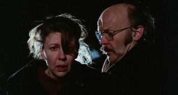 Movie still from “Black Christmas” (1974), directed by Bob Clark – An older man and a younger woman in the dark; Close Up shot, Low angle