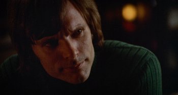 Movie still from “Black Christmas” (1974), directed by Bob Clark – A man's face in a dark room; Close Up shot, Over the shoulder angle