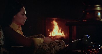 Movie still from “Black Christmas” (1974), directed by Bob Clark – A woman sitting in front of a fire place; Medium shot, Over the shoulder angle