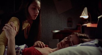 Movie still from “Black Christmas” (1974), directed by Bob Clark – A young man laying in a bed with a woman; Close Up shot, Low angle