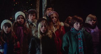Movie still from “Black Christmas” (1974), directed by Bob Clark – A group of children standing next to each other in front of lights; Medium shot, Low angle