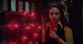 Movie still from “Black Christmas” (1974), directed by Bob Clark – A woman standing in front of a christmas tree; Close Up shot, Low angle