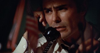 Movie still from “Black Christmas” (1974), directed by Bob Clark – A person talking on a phone; Close Up shot, Low angle
