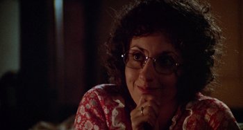 Movie still from “Black Christmas” (1974), directed by Bob Clark – A person wearing glasses with her hand under her chin; Close Up shot, Over the shoulder angle