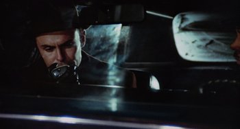 Movie still from “Black Christmas” (1974), directed by Bob Clark – A man with a knife in his mouth in a car; Close Up shot, Low angle