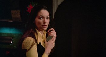 Movie still from “Black Christmas” (1974), directed by Bob Clark – A woman holding a cell phone in her hand; Close Up shot, High angle