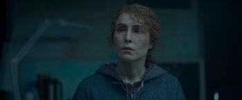 Movie still from “Black Crab” (2022), directed by Adam Berg – A woman with red curly hair wearing a sweater; Close Up shot, Low angle