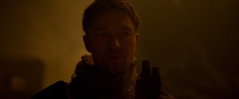 Movie still from “Black Crab” (2022), directed by Adam Berg – A person wearing a jacket; Close Up shot, Over the shoulder angle