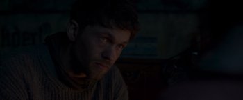 Movie still from “Black Crab” (2022), directed by Adam Berg – A person looking at the camera; Close Up shot, Over the shoulder angle