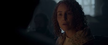 Movie still from “Black Crab” (2022), directed by Adam Berg – A person with curly red hair; Close Up shot, Over the shoulder angle