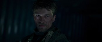 Movie still from “Black Crab” (2022), directed by Adam Berg – A person wearing a jacket; Close Up shot, Low angle