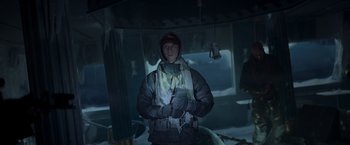 Movie still from “Black Crab” (2022), directed by Adam Berg – A man standing in a dark room holding a flashlight; Medium shot, Low angle