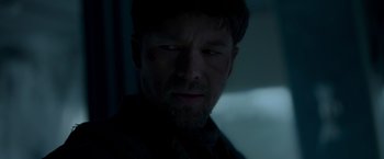 Movie still from “Black Crab” (2022), directed by Adam Berg – A person looking at the camera; Close Up shot, Low angle