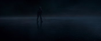 Movie still from “Black Crab” (2022), directed by Adam Berg – A person standing in the middle of the night; Extreme Wide shot, High angle