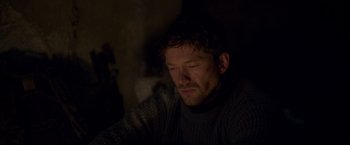 Movie still from “Black Crab” (2022), directed by Adam Berg – A person wearing a sweater; Close Up shot, Over the shoulder angle