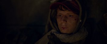 Movie still from “Black Crab” (2022), directed by Adam Berg – A young man with a bandage on his face; Close Up shot, Low angle