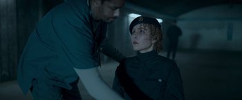 Movie still from “Black Crab” (2022), directed by Adam Berg – A man and a boy in a room; Medium shot, Over the shoulder angle