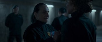 Movie still from “Black Crab” (2022), directed by Adam Berg – A man in a black jacket is looking at another man in a black jacket; Close Up shot, Over the shoulder angle