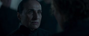 Movie still from “Black Crab” (2022), directed by Adam Berg – An older man looking into the distance in a dimly - lit room; Close Up shot, Over the shoulder angle