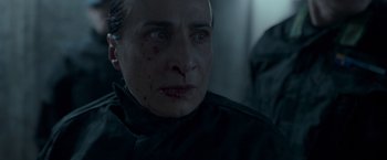 Movie still from “Black Crab” (2022), directed by Adam Berg – A person with blood on their face; Close Up shot, Over the shoulder angle