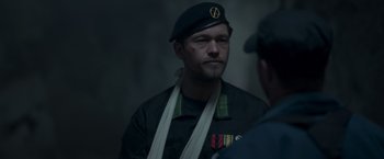 Movie still from “Black Crab” (2022), directed by Adam Berg – A man in a military uniform is talking to another man; Close Up shot, Over the shoulder angle