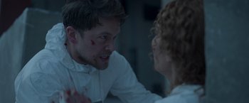 Movie still from “Black Crab” (2022), directed by Adam Berg – A man and a woman are fighting in a room; Close Up shot, Over the shoulder angle