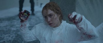 Movie still from “Black Crab” (2022), directed by Adam Berg – A woman in a white shirt with blood on her face; Medium shot, High angle