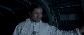 Movie still from “Black Crab” (2022), directed by Adam Berg – A man in a lab coat with blood all over his face; Close Up shot, High angle