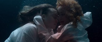 Movie still from “Black Crab” (2022), directed by Adam Berg – Two women are kissing under water in the ocean; Close Up shot, Overhead angle
