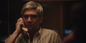 Movie still from “BlackBerry” (2023), directed by Matt Johnson – A man with glasses talking on a phone; Close Up shot, Over the shoulder angle