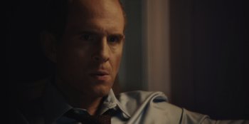 Movie still from “BlackBerry” (2023), directed by Matt Johnson – A person wearing a shirt and a tie; Close Up shot, Over the shoulder angle