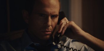 Movie still from “BlackBerry” (2023), directed by Matt Johnson – A person talking on a phone; Close Up shot, Low angle