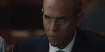 Movie still from “BlackBerry” (2023), directed by Matt Johnson – A man in a suit and a tie; Close Up shot, Over the shoulder angle