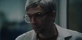 Movie still from “BlackBerry” (2023), directed by Matt Johnson – A person wearing glasses; Close Up shot, Over the shoulder angle
