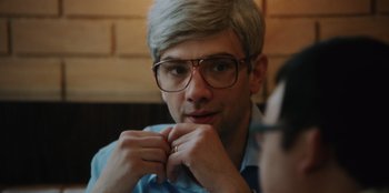 Movie still from “BlackBerry” (2023), directed by Matt Johnson – A man with glasses is sitting in front of another man; Close Up shot, Over the shoulder angle
