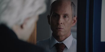 Movie still from “BlackBerry” (2023), directed by Matt Johnson – A man in a white shirt and a red neck tie; Close Up shot, Over the shoulder angle