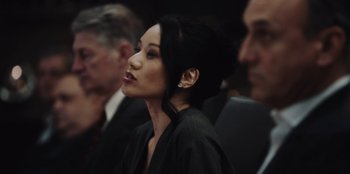 Movie still from “BlackBerry” (2023), directed by Matt Johnson – A woman in a black jacket is looking to her left; Close Up shot, Over the shoulder angle